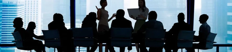 Graduates in a group in a board room
